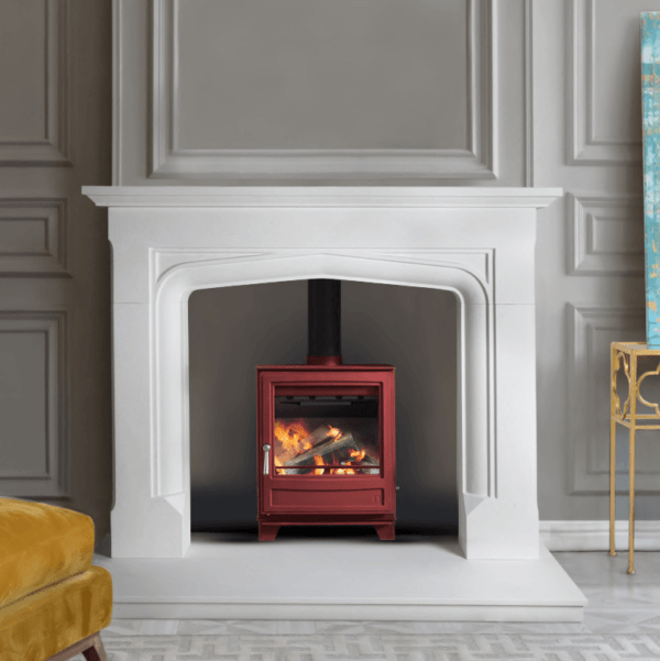 The 54" Alexander Limestone marble surround combines clean lines with strong architectural detail pictured with a limestone back panel and hearth and brick red stove
