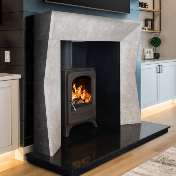 The 54" Edge Nimbus Grey marble surround combines clean lines with strong architectural detail pictured here with a black granite hearth and Bray stove also in black