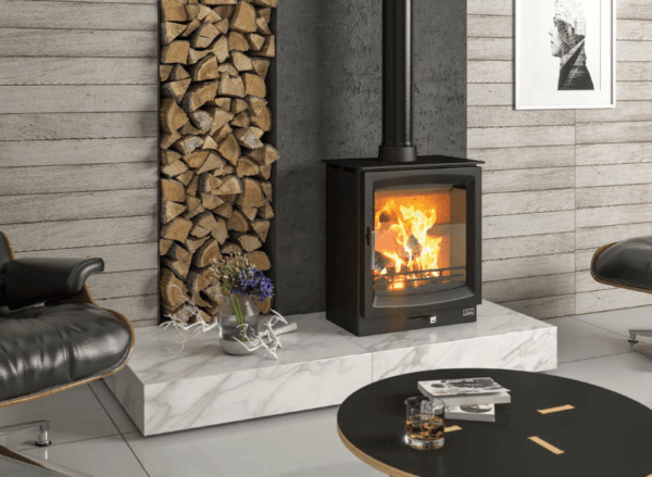 Purposely designed to maximize the view of the fire, the minimal styling of the Burnbright fits comfortably into any fireside situation. Pictured here in black with matching black pipework, marble hearth and packed log store
