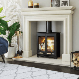 The new Hampton is a Steel body stove with classic cast iron double doors. Pictured here in black with matching black pipe work and a warm fire blazing behind the viewing glass of each of the double doors. The fire is set within an elegant white surround and hearth