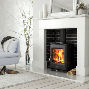 The Lincoln 5kW room heater stove combines contemporary stove design with a superb cast iron build. Pictured here in black with large viewing window and a white stone surround