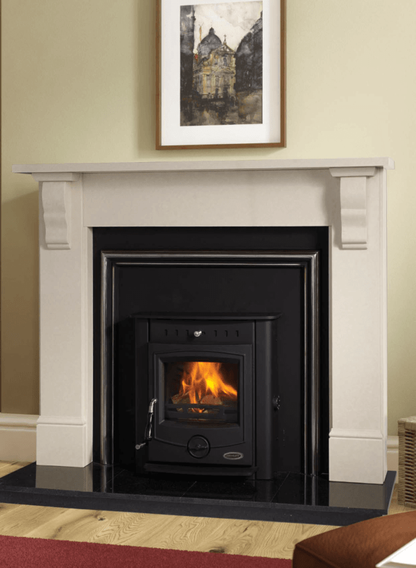 The Achill multi-fuel Insert boiler in black, inset into a black granite insert with silver trim and white stone fireplace surround