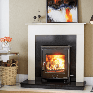 The Arklow is a fully cast iron multi fuel stove with over 79% efficiency. Pictured here with a blazing fire behind a large viewing window, the stove is set into a black granite insert, on top of a black granite hearth and set into a white marble fireplace surround