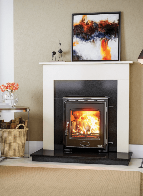 The Arklow is a fully cast iron multi fuel stove with over 79% efficiency. Pictured here with a blazing fire behind a large viewing window, the stove is set into a black granite insert, on top of a black granite hearth and set into a white marble fireplace surround